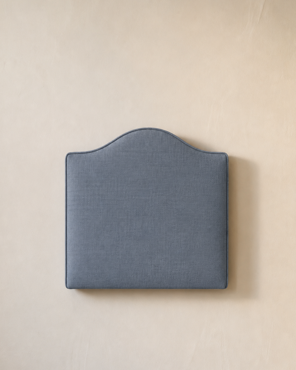 Blue headboard on a beige wall