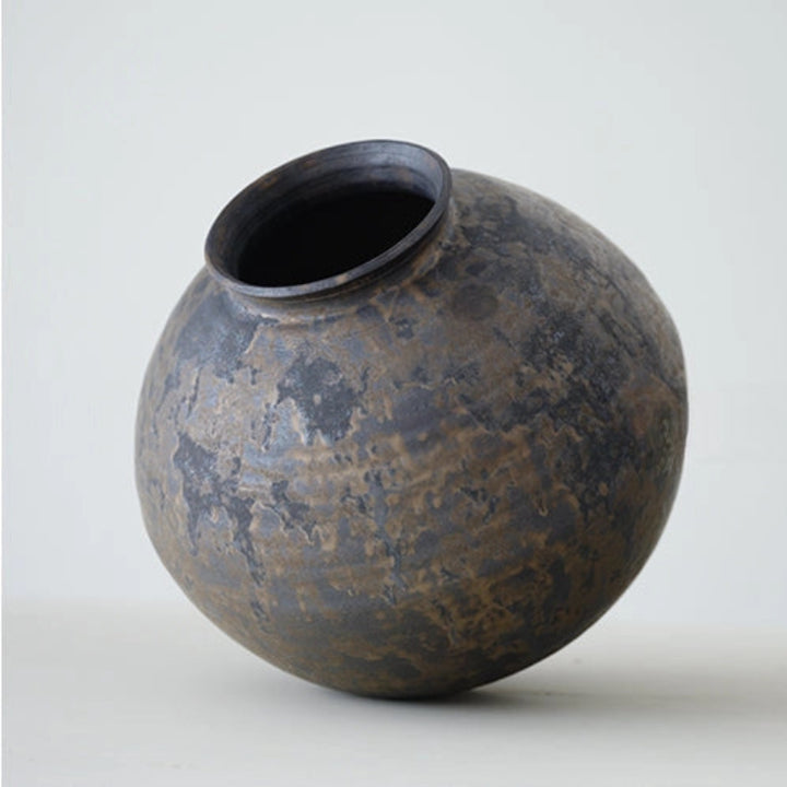 Textured ceramic vase on a plain background