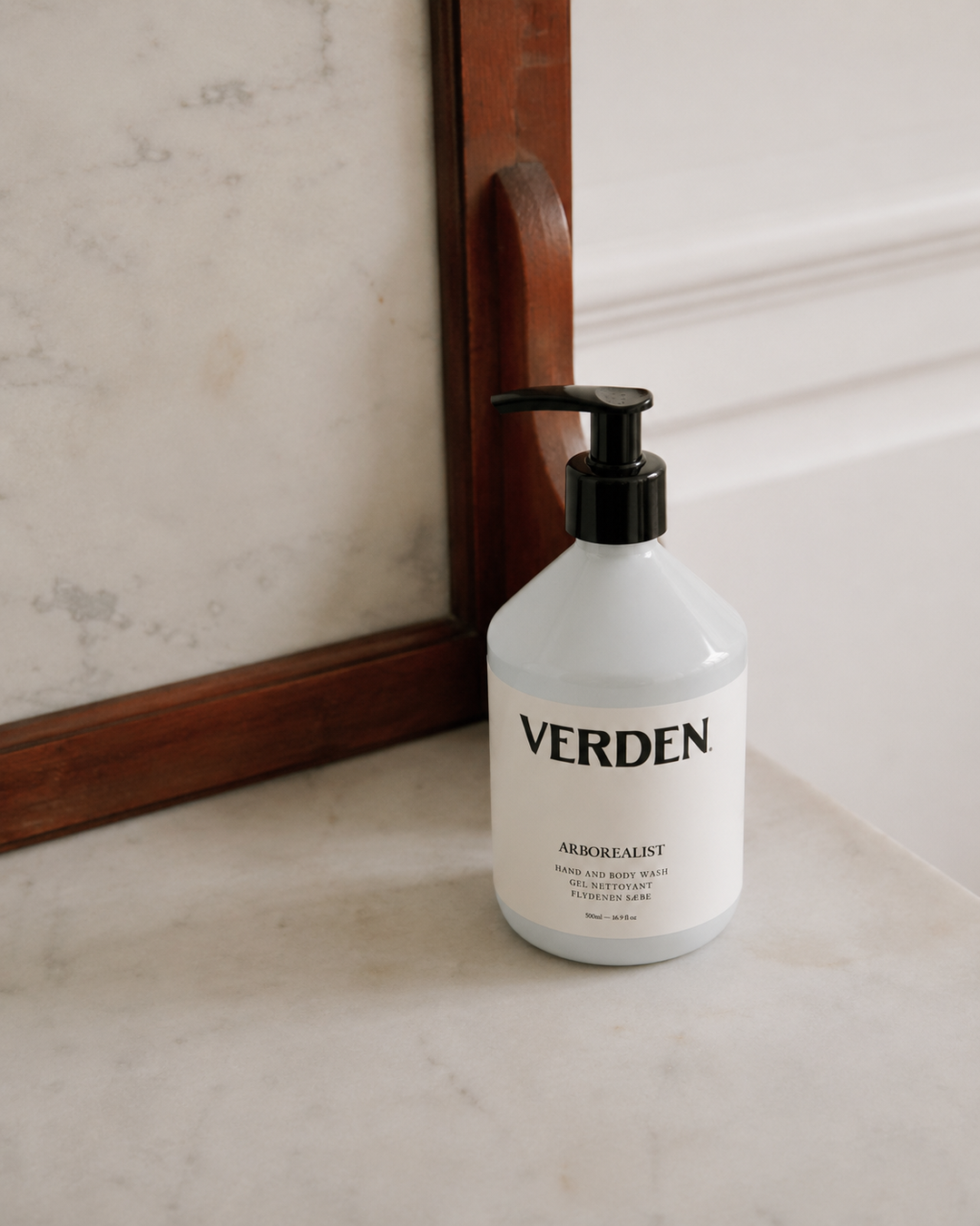 Verden bottle on a marble surface with a mirror in the background