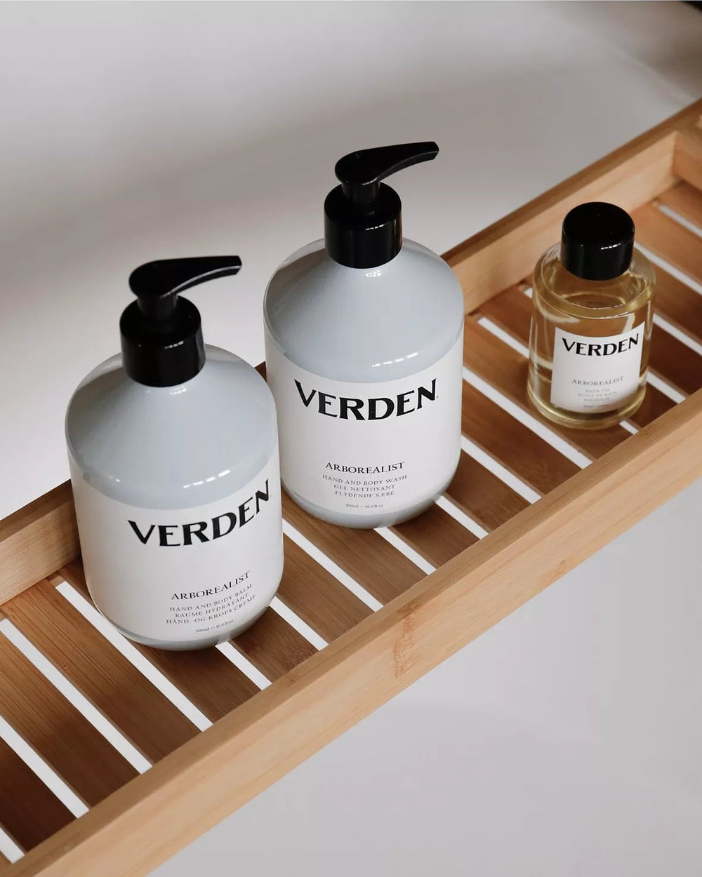Three 'VERDEN' branded bottles on a wooden tray.