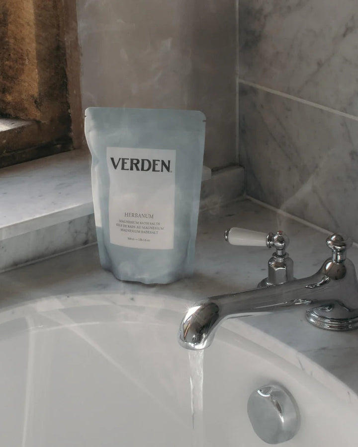 Verden product packaging on a bathroom counter with running water.