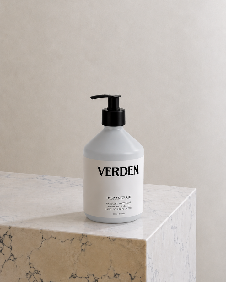 White bottle with black pump labeled 'VERDEN' on a marble surface with a neutral background