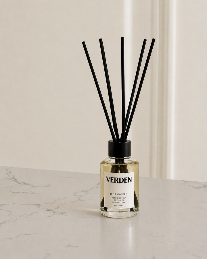 Verden diffuser bottle with black sticks on a marble surface